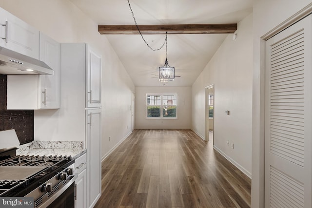 kitchen featuring dark hardwood / wood-style flooring, high end stainless steel range oven, white cabinets, vaulted ceiling with beams, and a chandelier