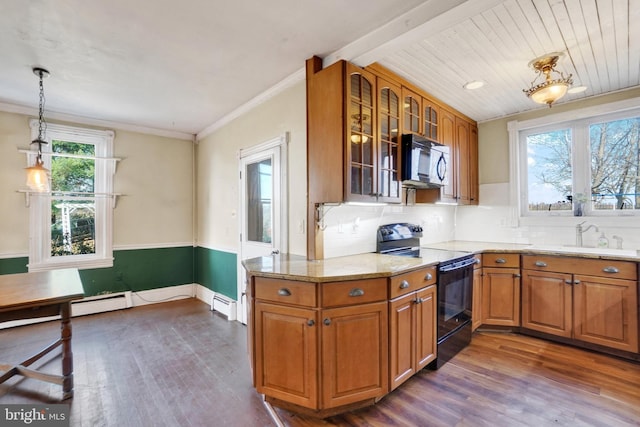 kitchen featuring dark hardwood / wood-style flooring, a baseboard heating unit, sink, black appliances, and pendant lighting