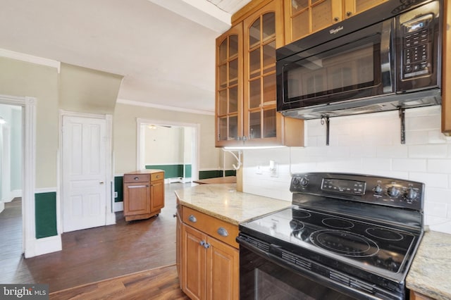 kitchen featuring light stone countertops, crown molding, black appliances, and dark hardwood / wood-style floors