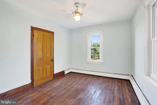 spare room featuring a baseboard radiator, ceiling fan, and dark wood-type flooring