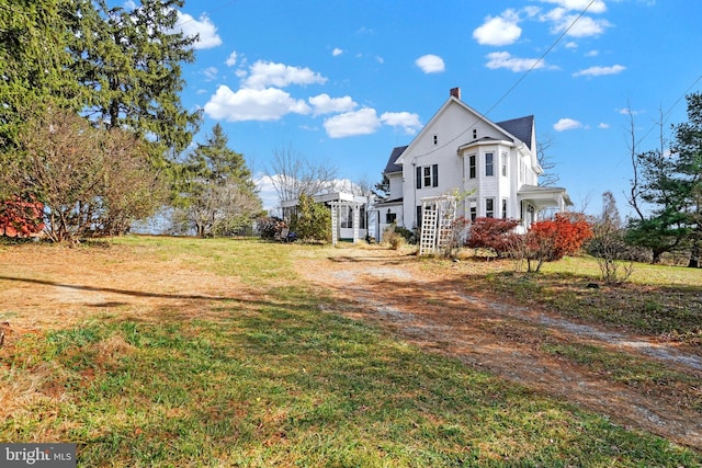 view of side of property with a lawn