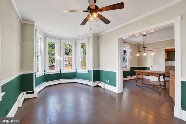 spare room featuring dark hardwood / wood-style floors, ceiling fan, baseboard heating, and crown molding