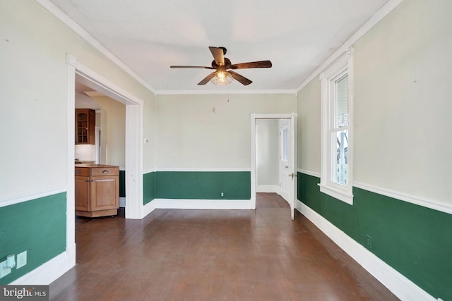 unfurnished room with dark hardwood / wood-style floors, ceiling fan, and ornamental molding