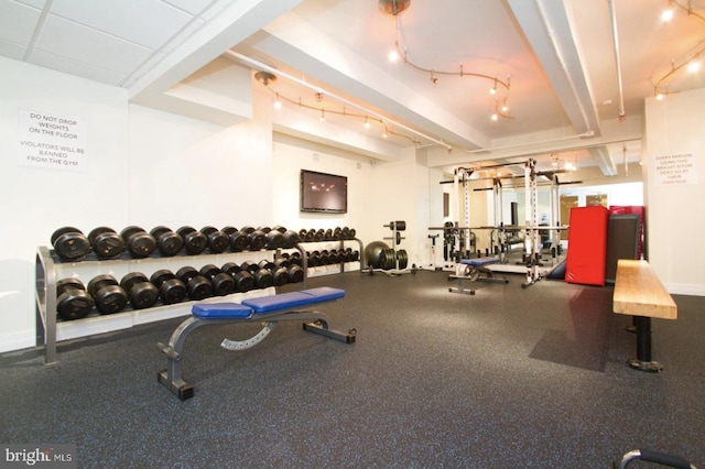 workout area featuring track lighting