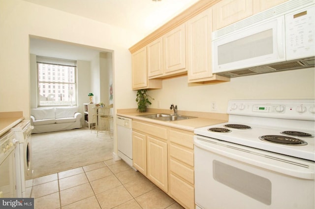 kitchen featuring sink, light colored carpet, and white appliances