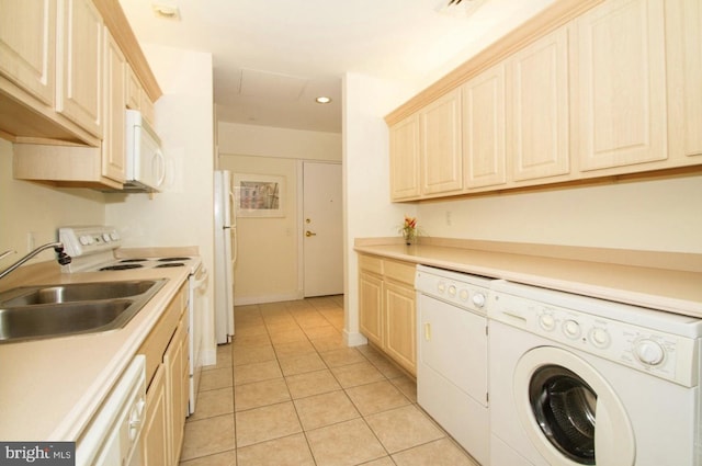 interior space featuring light tile patterned flooring, separate washer and dryer, and sink