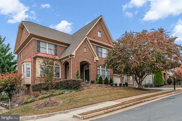 view of front of home featuring a front lawn and a garage