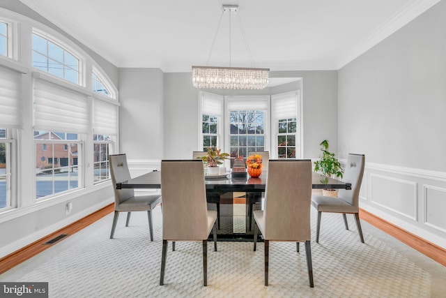7238 Farr St, Annandale, VA 22003 - dining room featuring a chandelier, ornamental molding, wood finished floors, and wainscoting
