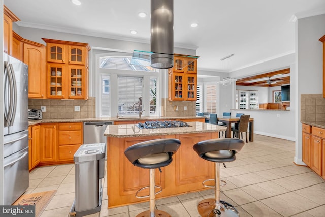 7238 Farr St, Annandale, VA 22003 - kitchen with appliances with stainless steel finishes, a kitchen island, ornamental molding, decorative backsplash, and a sink
