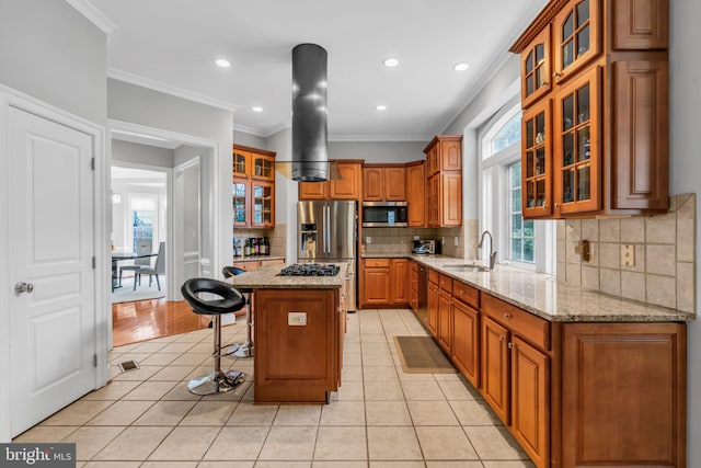 7238 Farr St, Annandale, VA 22003 - kitchen featuring stainless steel appliances, a sink, brown cabinetry, a breakfast bar, and light tile patterned floors