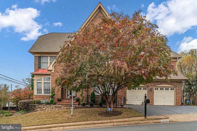7238 Farr St, Annandale, VA 22003 - view of property hidden behind natural elements featuring driveway, brick siding, a front lawn, and a garage