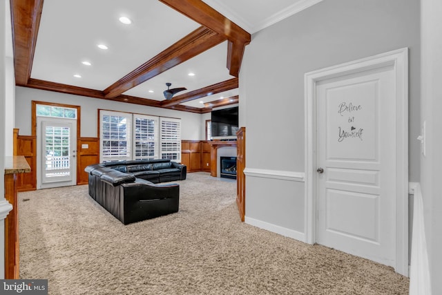 7238 Farr St, Annandale, VA 22003 - carpeted living area featuring a glass covered fireplace, crown molding, a wainscoted wall, beam ceiling, and recessed lighting