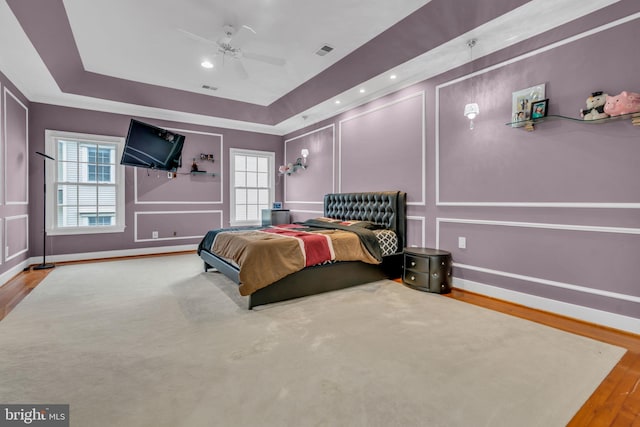 7238 Farr St, Annandale, VA 22003 - bedroom featuring a decorative wall, wood finished floors, a raised ceiling, baseboards, and ceiling fan
