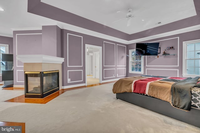 7238 Farr St, Annandale, VA 22003 - bedroom with a decorative wall, ornamental molding, multiple windows, wood finished floors, and a fireplace