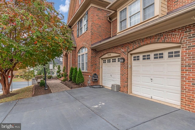 7238 Farr St, Annandale, VA 22003 - view of property exterior with an attached garage, brick siding, and driveway