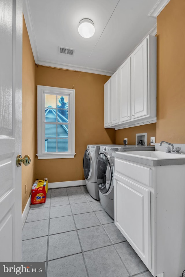 7238 Farr St, Annandale, VA 22003 - laundry area with cabinet space, separate washer and dryer, light tile patterned flooring, crown molding, and baseboards