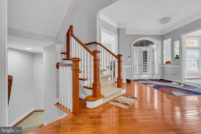 7238 Farr St, Annandale, VA 22003 - entrance foyer featuring crown molding, stairs, hardwood / wood-style flooring, a wainscoted wall, and a decorative wall