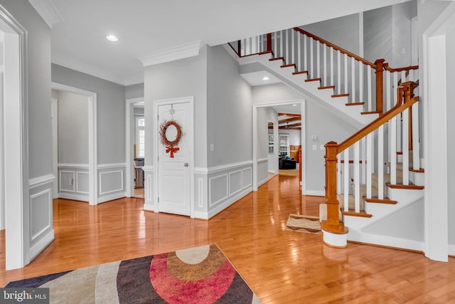 7238 Farr St, Annandale, VA 22003 - entrance foyer with wood finished floors, stairway, ornamental molding, and recessed lighting