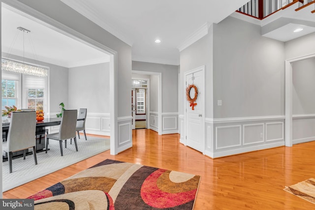 7238 Farr St, Annandale, VA 22003 - dining space featuring ornamental molding, wood finished floors, a chandelier, a wainscoted wall, and a decorative wall