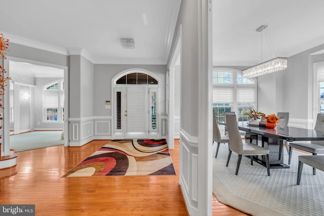 7238 Farr St, Annandale, VA 22003 - entryway featuring a chandelier, ornamental molding, wood finished floors, a wainscoted wall, and a decorative wall