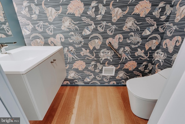 bathroom with hardwood / wood-style flooring and vanity