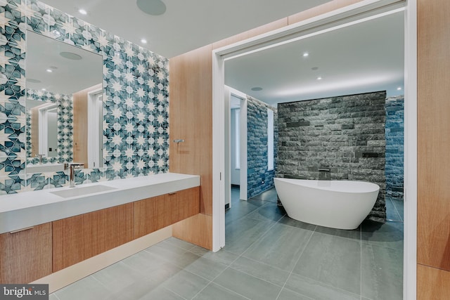 bathroom featuring vanity, tile patterned floors, and a bathing tub