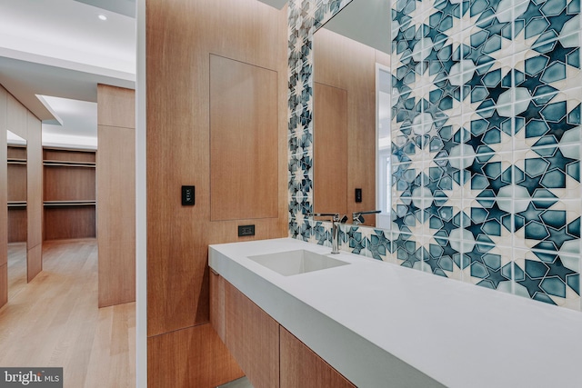 bathroom with hardwood / wood-style floors and sink