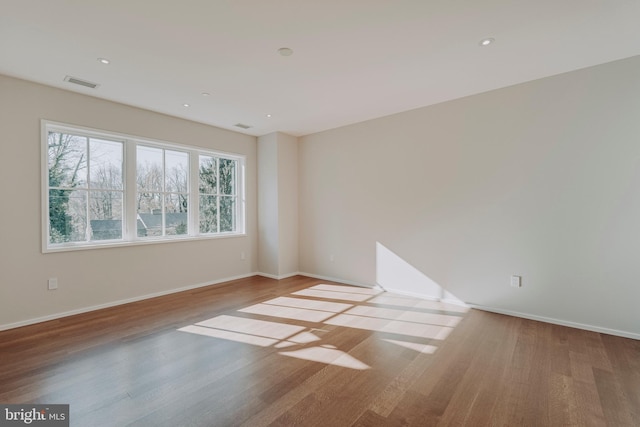 spare room with light hardwood / wood-style flooring