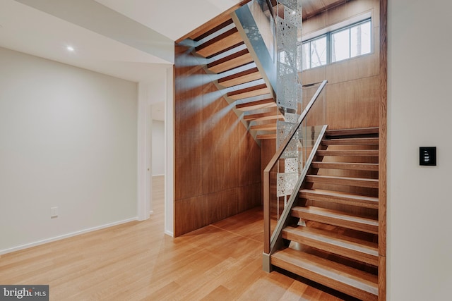 staircase with hardwood / wood-style floors