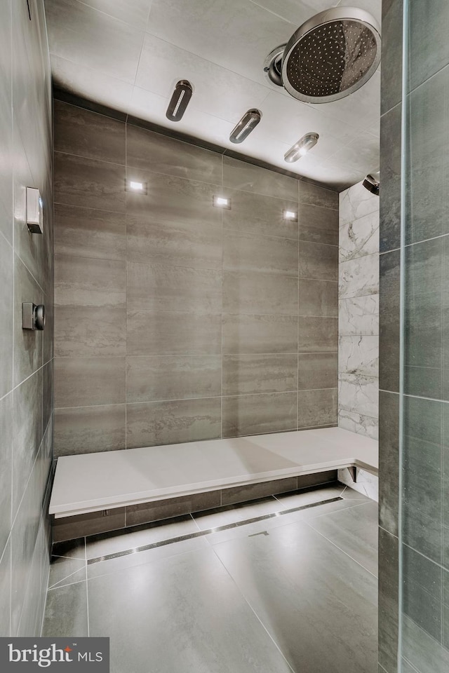 bathroom with tile walls and walk in shower