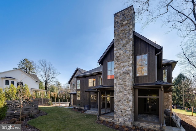 rear view of property featuring a patio area and a yard