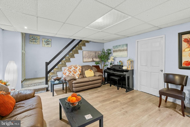 living room featuring a drop ceiling and wood-type flooring