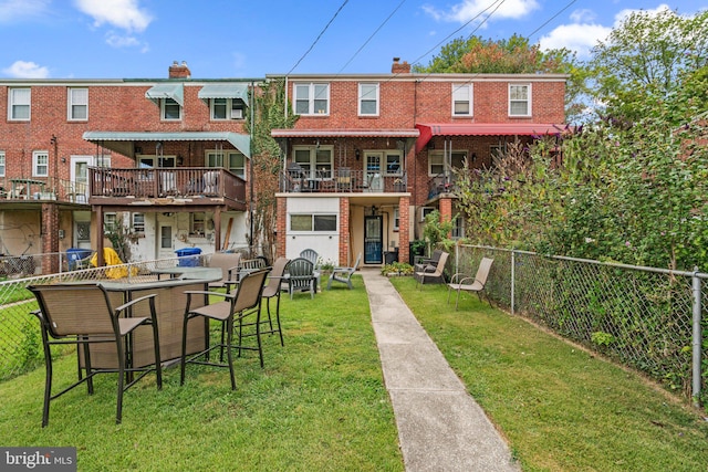 back of house featuring a yard and an outdoor bar