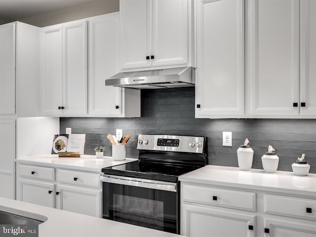 kitchen featuring decorative backsplash, white cabinetry, and stainless steel electric range