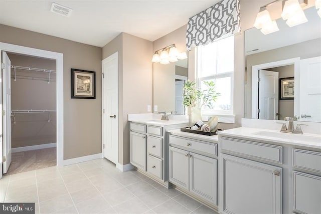 bathroom with tile patterned floors and vanity