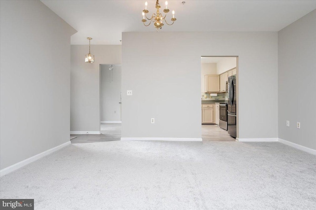 unfurnished living room featuring light carpet and an inviting chandelier