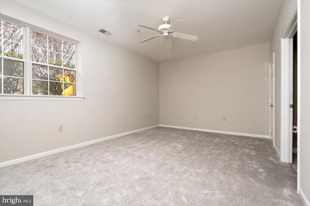 carpeted spare room featuring ceiling fan