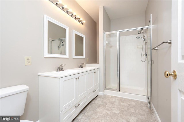 bathroom with toilet, vanity, and walk in shower