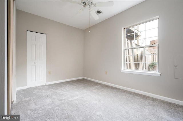 empty room featuring light colored carpet and ceiling fan