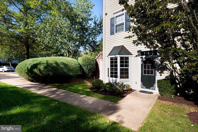 view of side of home featuring a yard