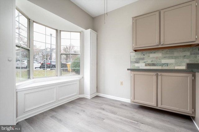 unfurnished dining area with plenty of natural light and light hardwood / wood-style flooring