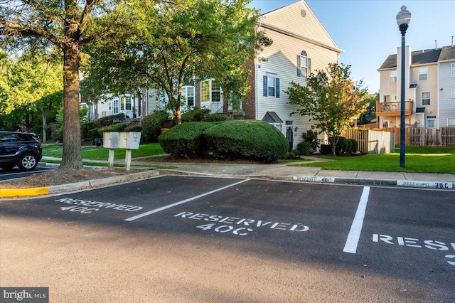 view of parking / parking lot featuring a mail area