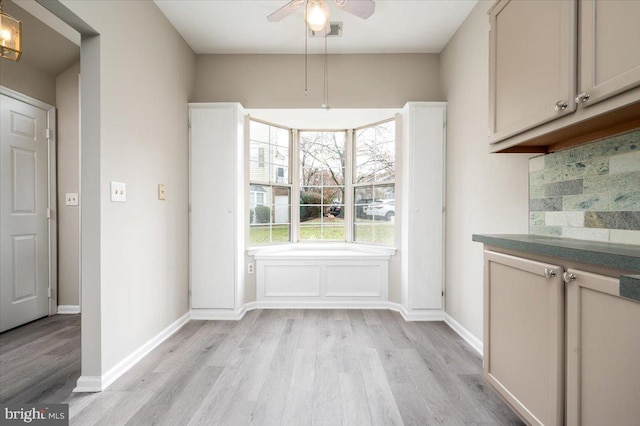 unfurnished dining area featuring ceiling fan and light wood-type flooring