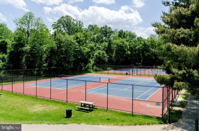 view of sport court featuring a lawn