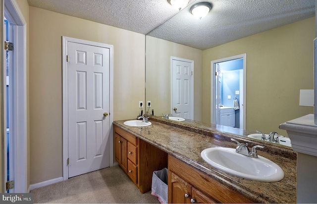 bathroom with vanity and a textured ceiling