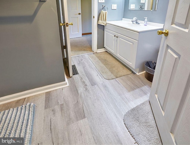 bathroom featuring vanity and hardwood / wood-style flooring