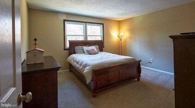 bedroom featuring light colored carpet and a textured ceiling