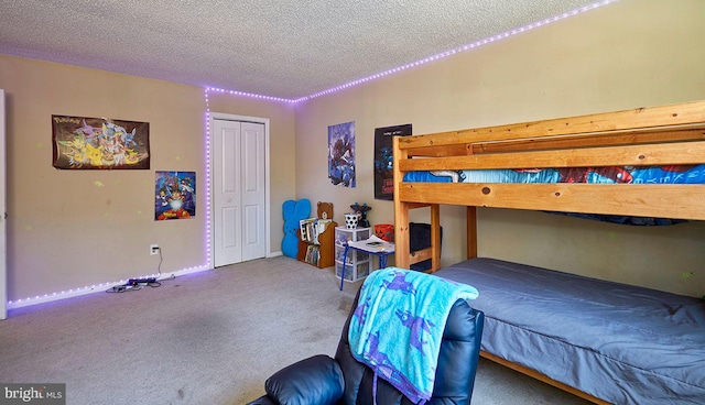 carpeted bedroom with a textured ceiling