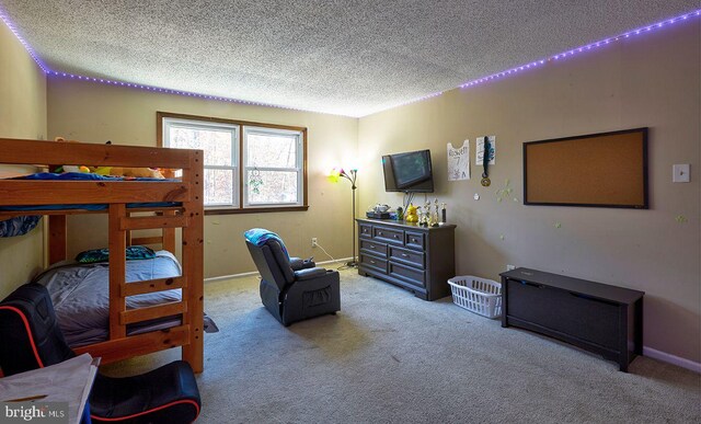 carpeted bedroom featuring a textured ceiling