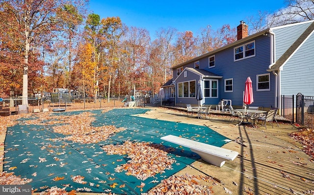 back of house with a patio and a covered pool